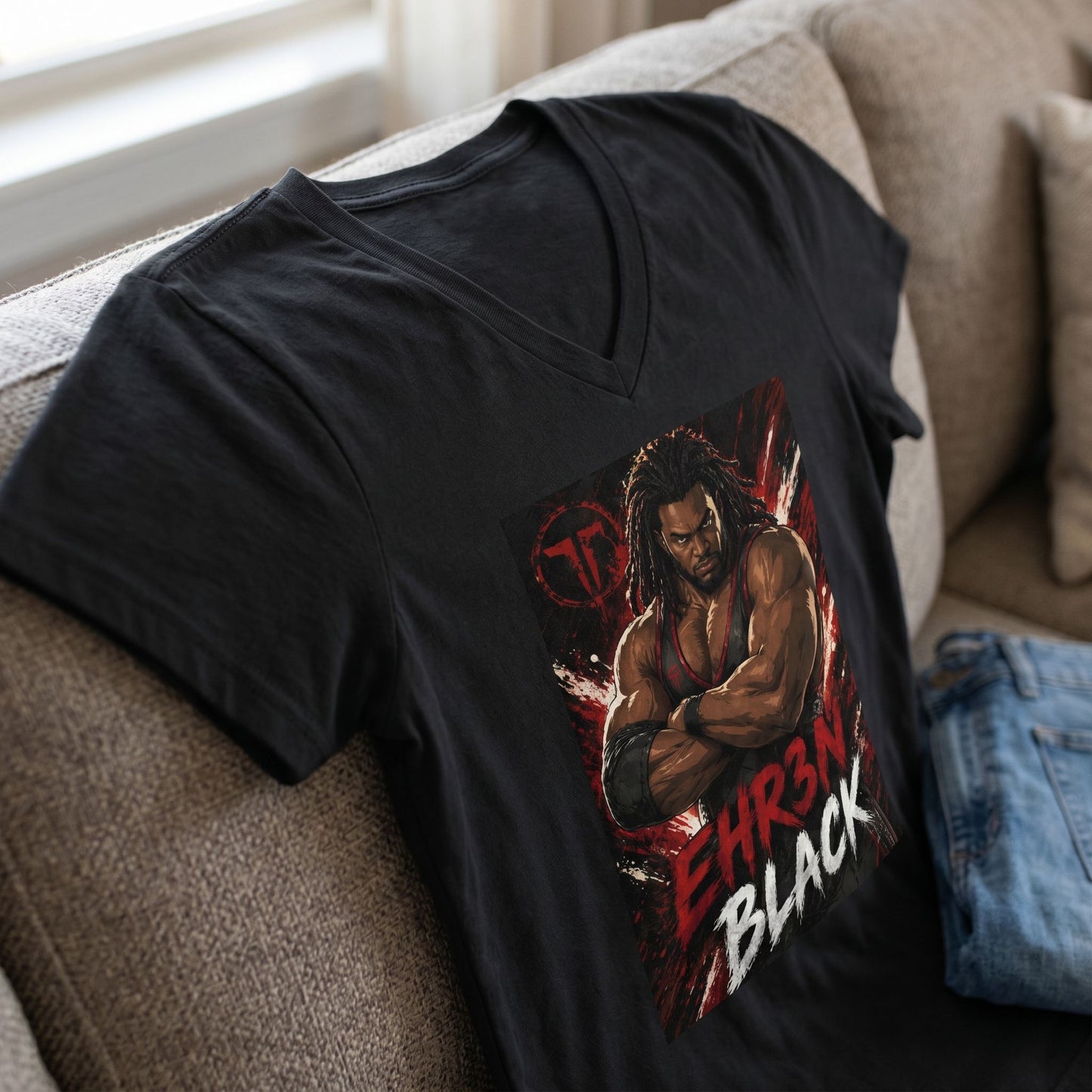 Lifestyle shot of EB Dominance V-neck T-shirt styled with jeans on textured sofa with soft indoor light.