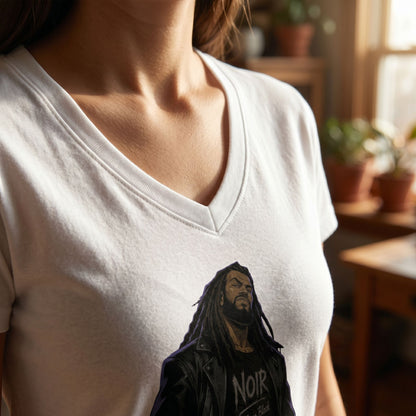 Detailed close-up of V-neck collar on model with natural backdrop, emphasizing stitching and fabric texture of the cotton t-shirt.